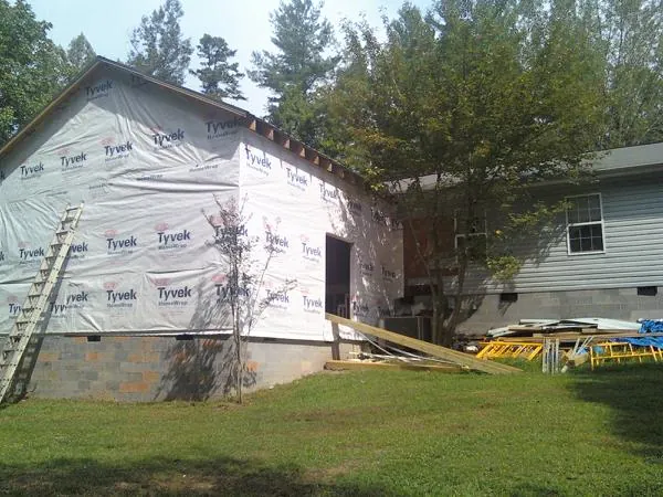Tyvek wrapped gable on a new room addition beside an existing home in Duxbury